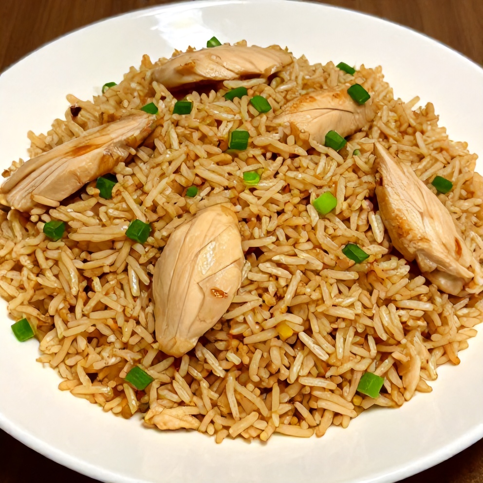 Coconut chicken served over rice with green onions