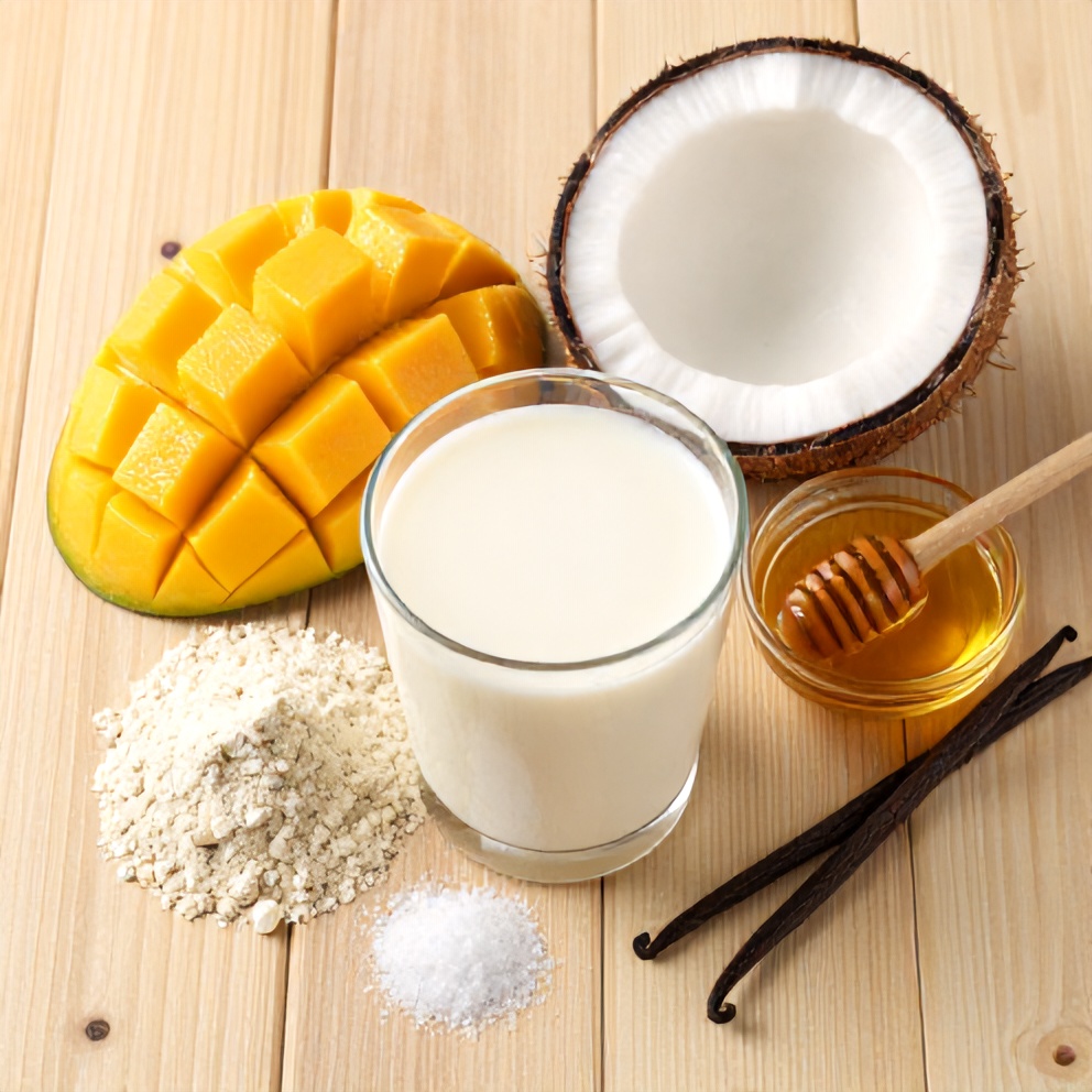 Raw ingredients for Mango Coconut Protein Shake on a wooden surface