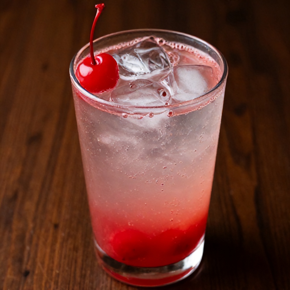 Glass of cherry limeade with a cherry garnish